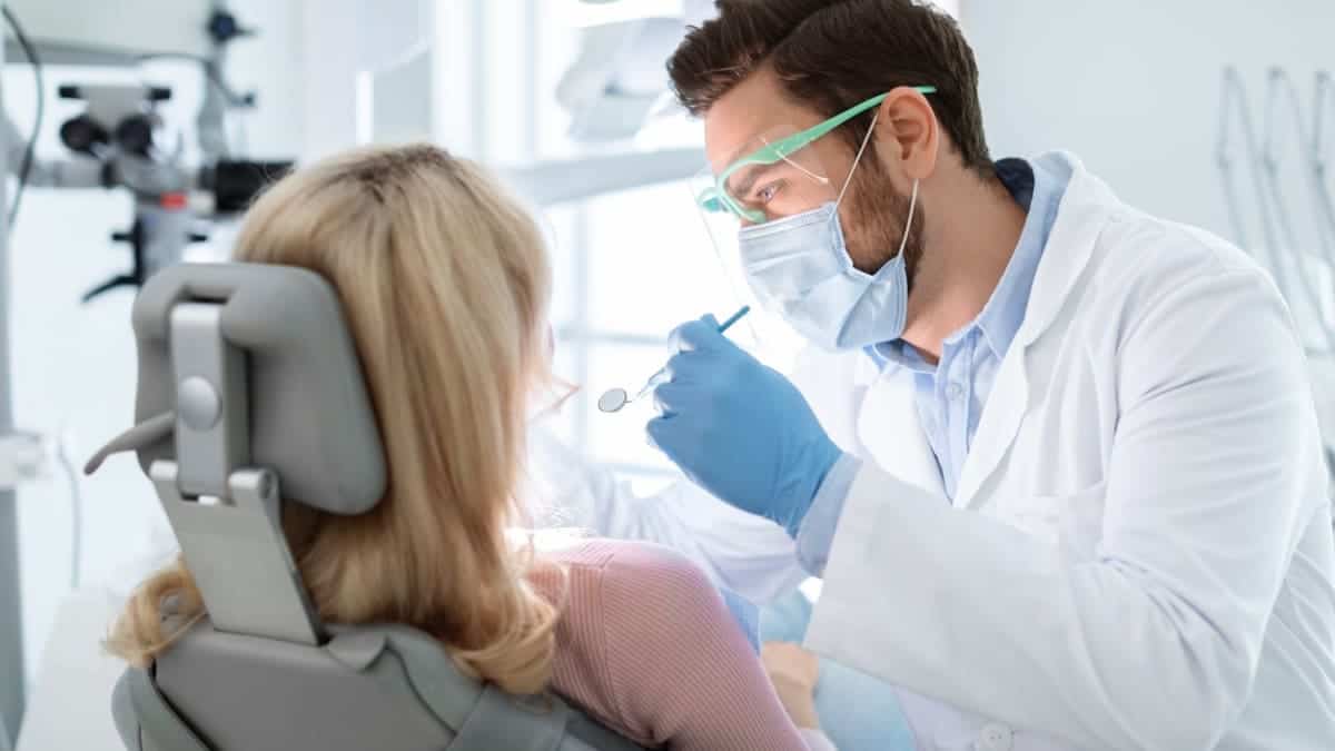 Patient receiving professional teeth whitening with a laser device Colchester